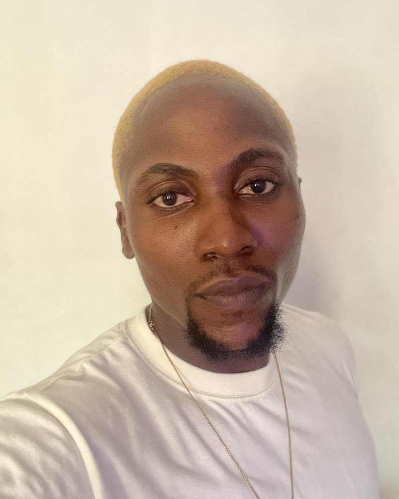 Victor with bleached hair, in a white T-shirt