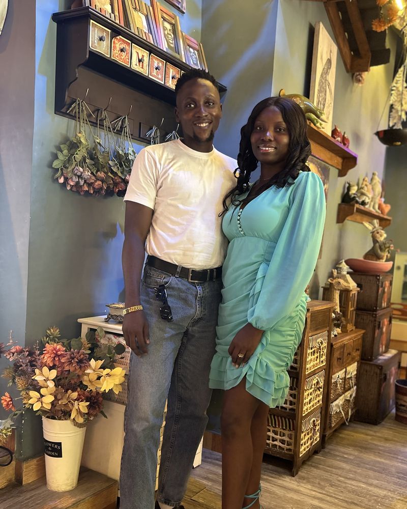 Victor and his wife standing together in a restaurant