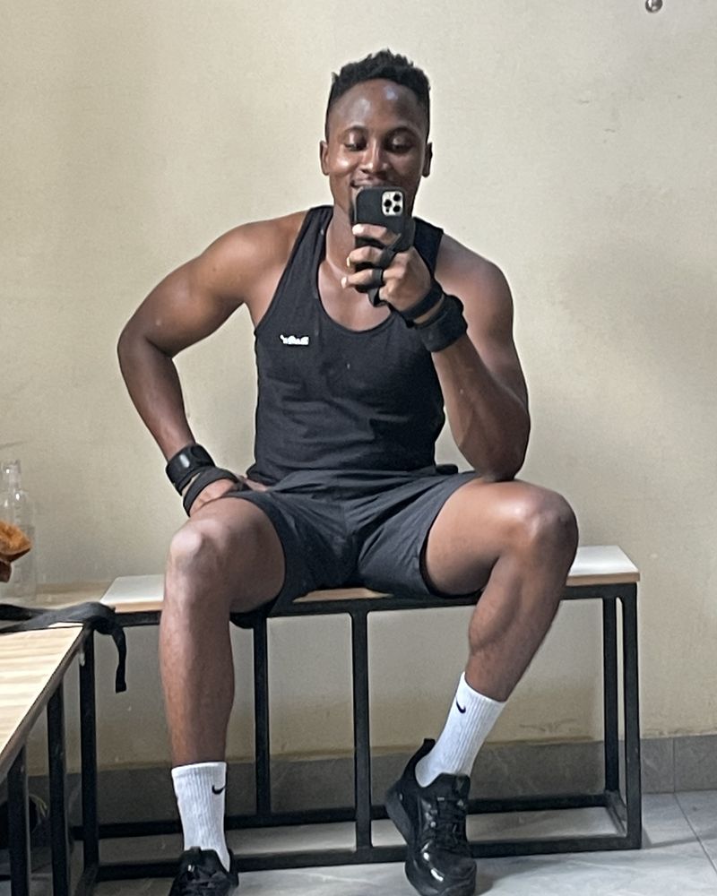 Victor resting on a gym bench between sets